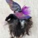 Witch on a stick facing back.  Bad hair day?